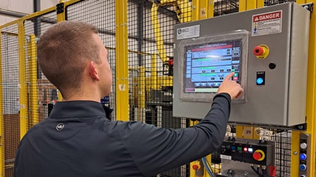 Systems integration engineer checks on a machine