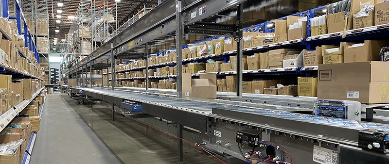 a conveyor belt with boxes on shelves